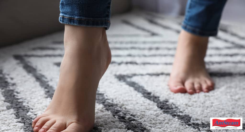 Bare feet walking across a carpet