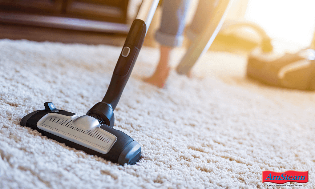 A woman vacuuming an area rug