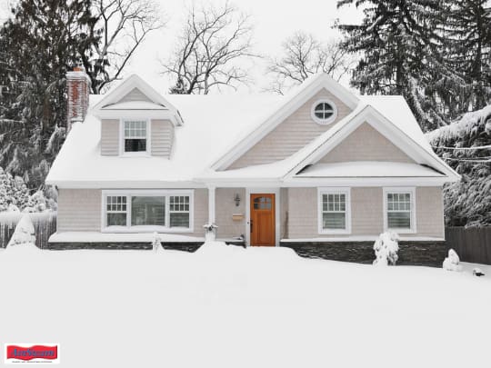 Exterior of home pictured in winter with snow of roof top